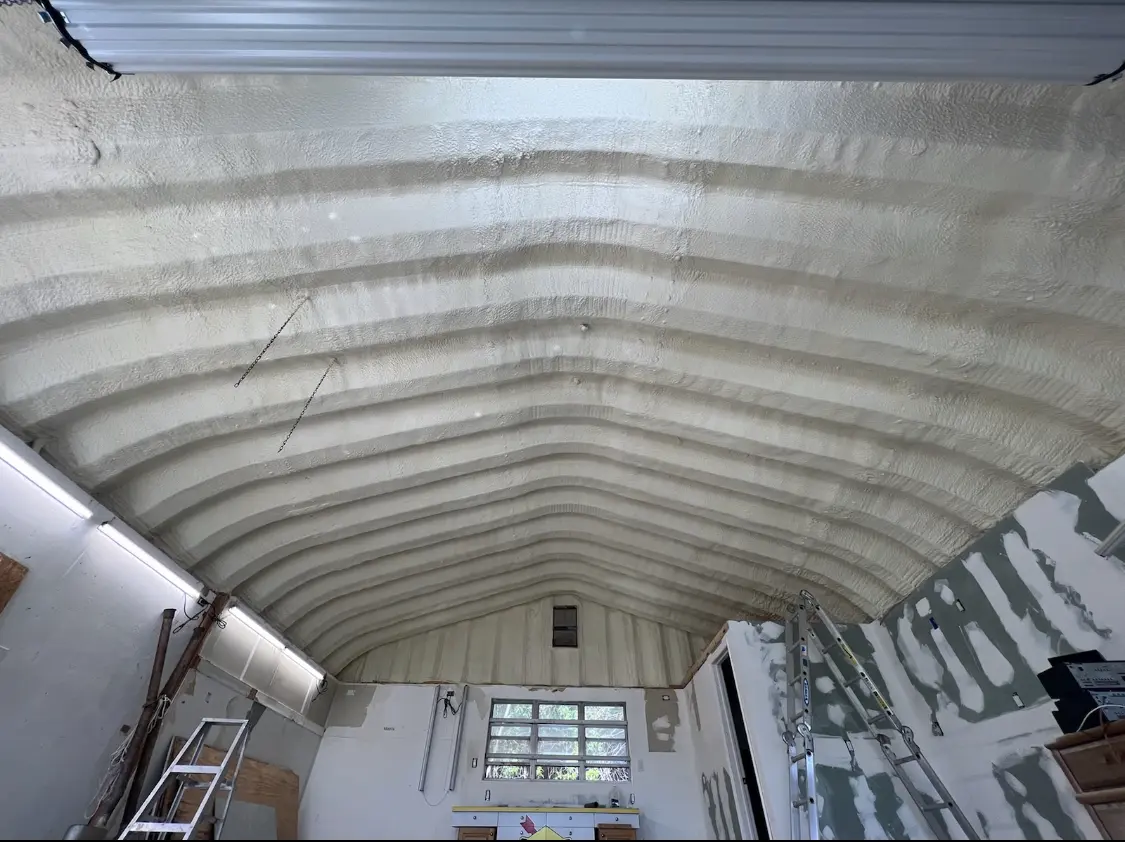 Spray polyurethane foam applied to the underside of a metal roof deck in Duxbury